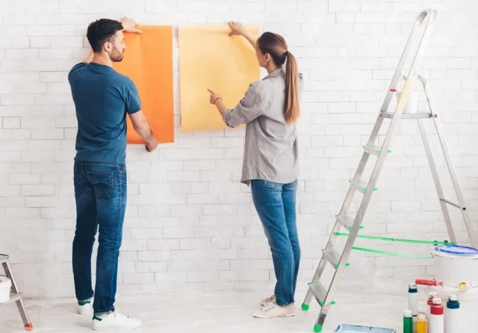 young happy couple choosing in what color painting their new house (1)